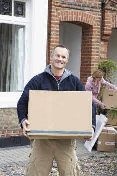 Removal team preparing a home move in Barnes with boxes and furniture