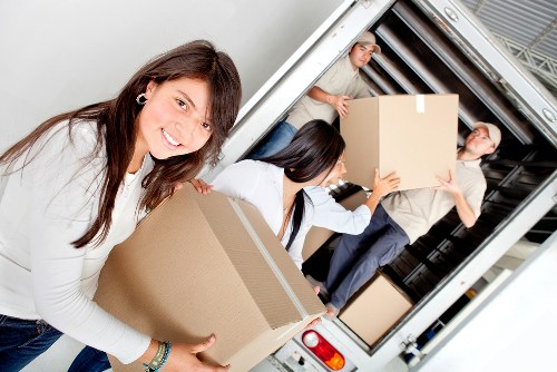 Team of removal specialists handling furniture in Barnes